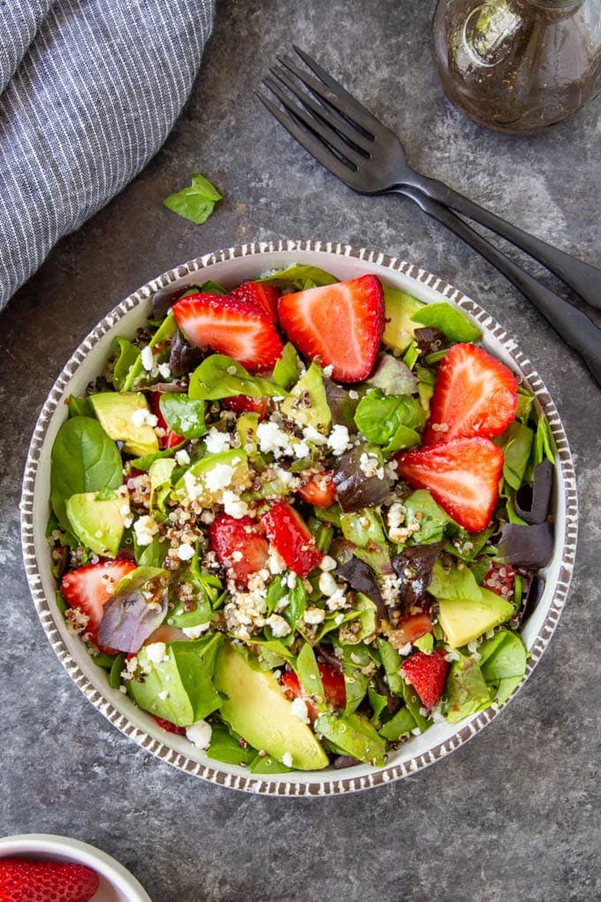 Strawberry spinach salad with quinoa and feta in a bowl