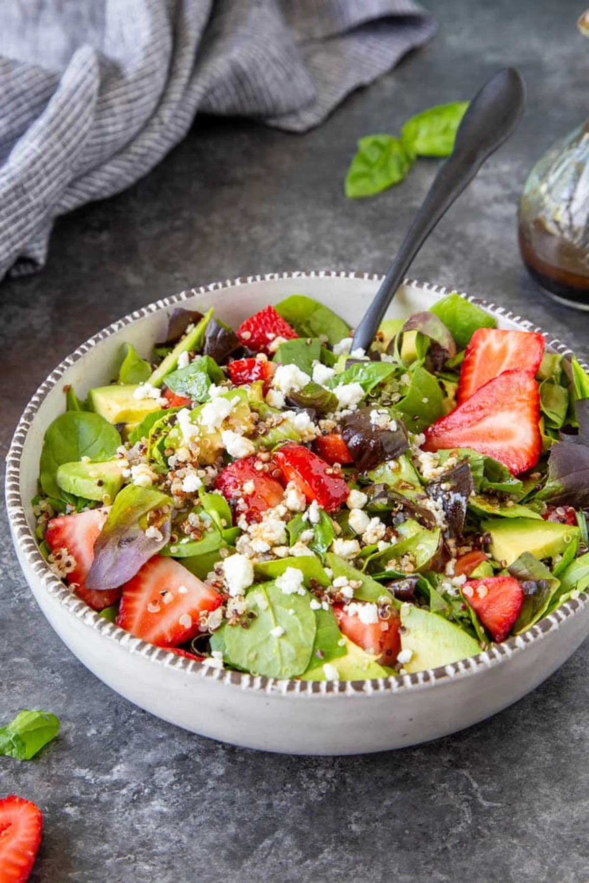Close-up of strawberry spinach salad with balsamic dressing