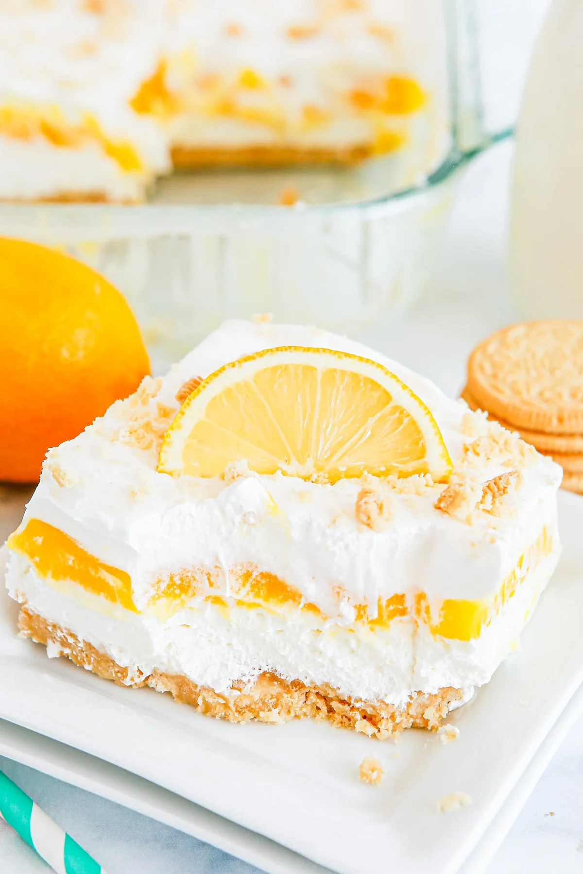 Slice of lemon lush no-bake layered dessert on a white plate