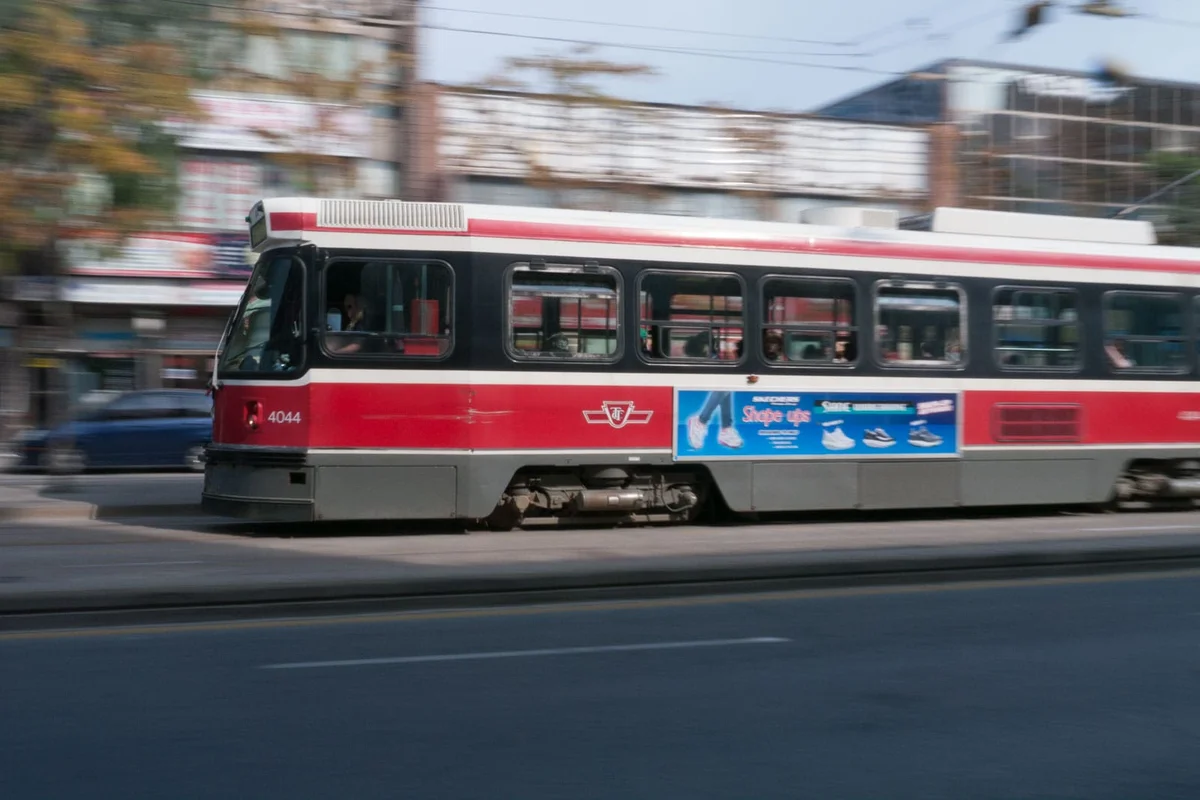 Toronto streetcar rolling down Queen Street in autumn
