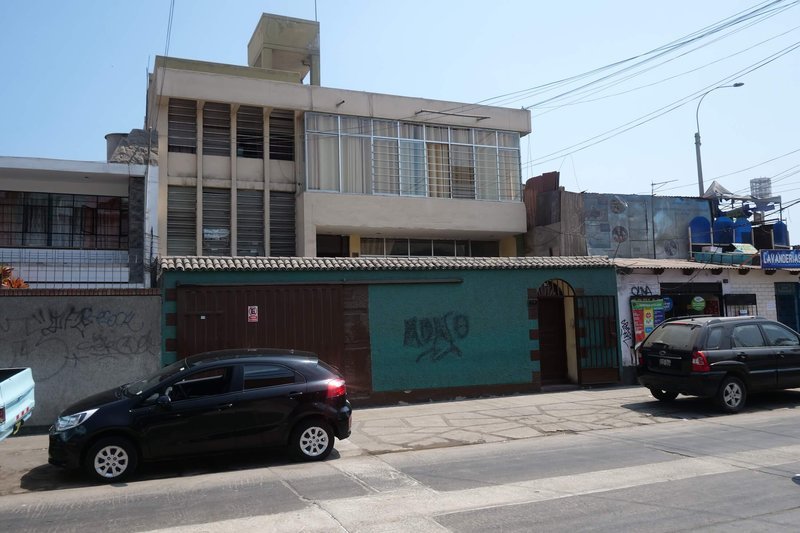 Street exterior of Chez Wong with teal wall