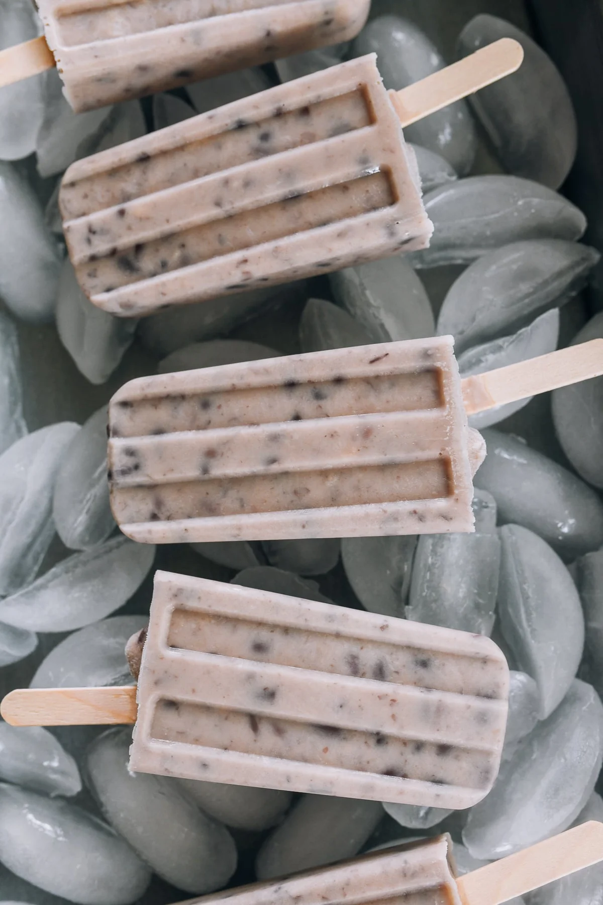 Close-up of red bean popsicles resting on ice cubes