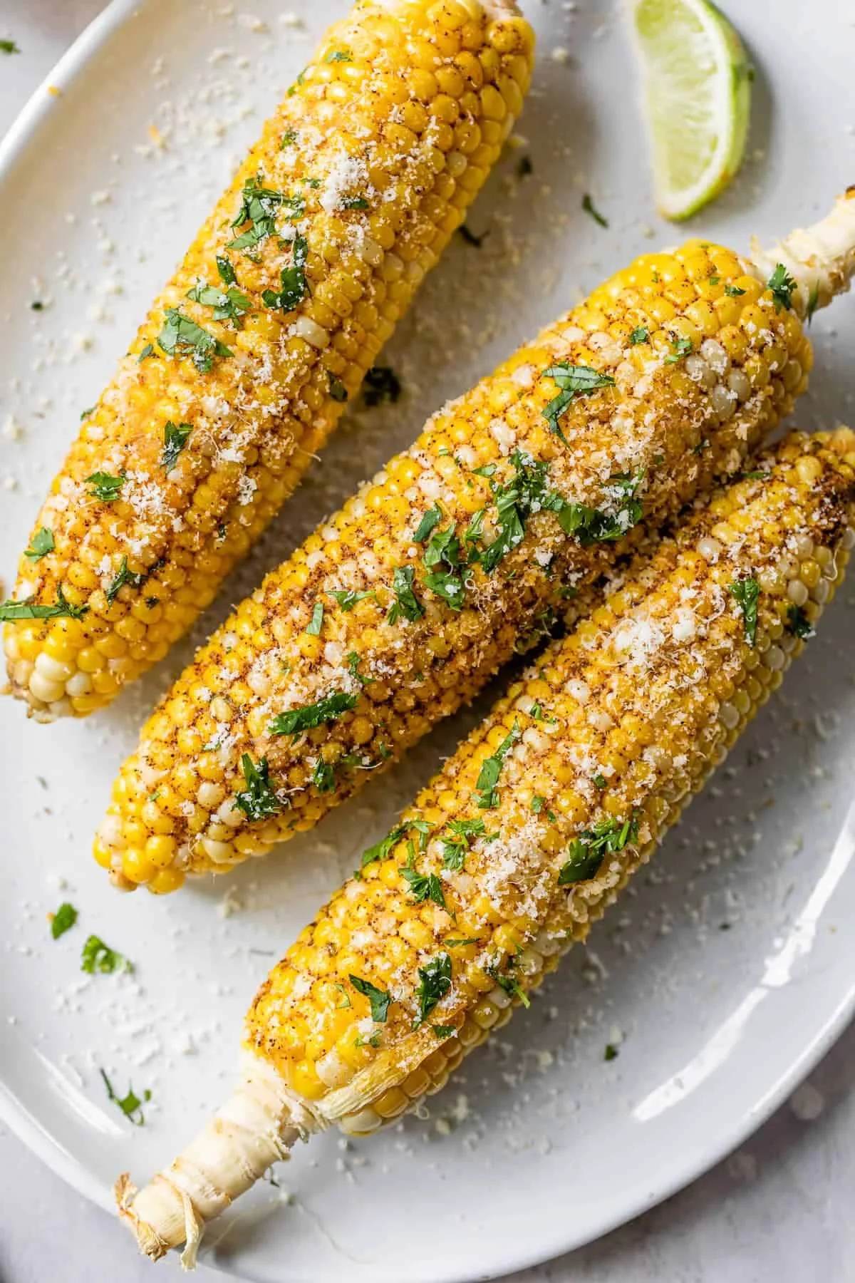 Grilled corn ears with charred kernels on a plate