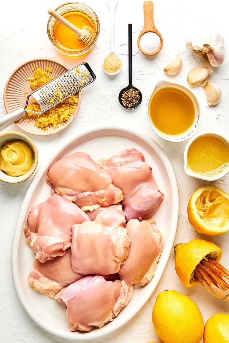 Flat lay of lemon pepper chicken marinade ingredients around raw chicken