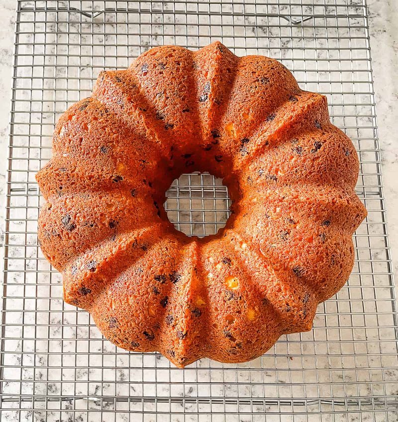 Baked chocolate chip bundt cake cooling upside down on a wire rack