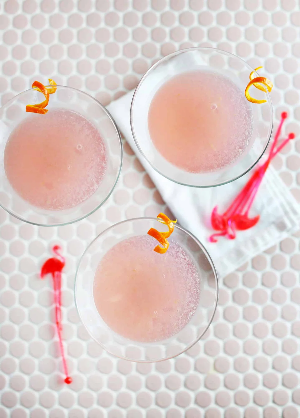Cosmopolitan cocktail ready to serve beside fresh citrus garnish