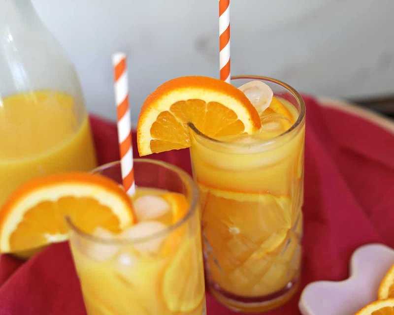 Finished screwdriver drinks garnished with orange slices and striped straws