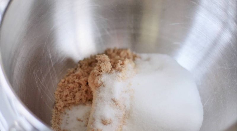 Brown and white sugar in a stainless mixing bowl
