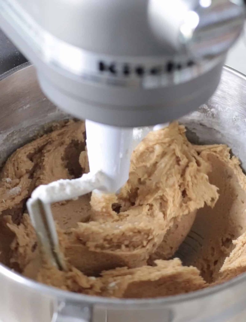 Cookie dough being mixed in a stand mixer