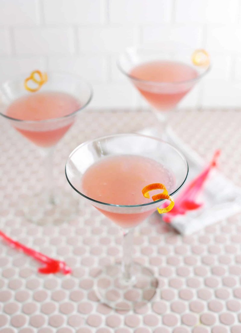 Finished Cosmopolitan cocktail in a stemmed glass with orange peel curl