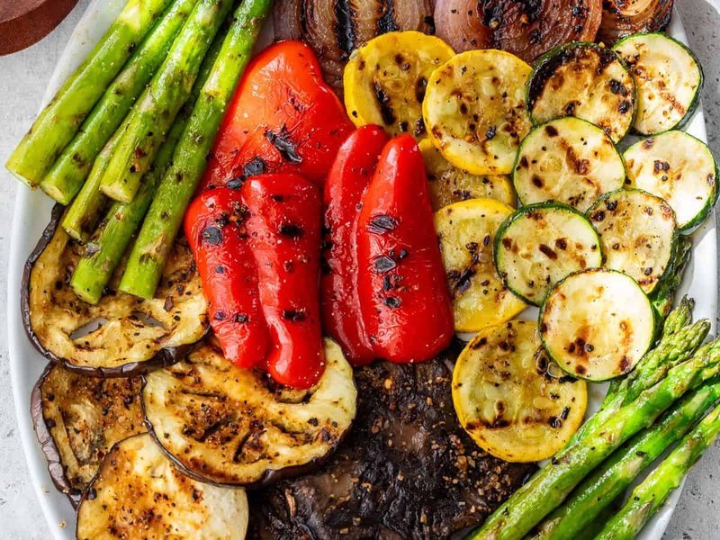 Mixed grilled vegetable platter with colorful charred vegetables