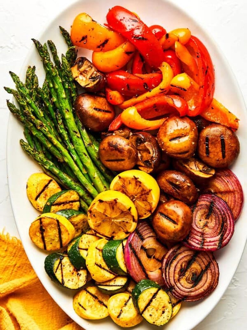 Grilled chicken platter styled with lemon and pepper garnish