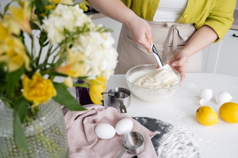 Mixing cake batter in a bowl with eggs and ingredients